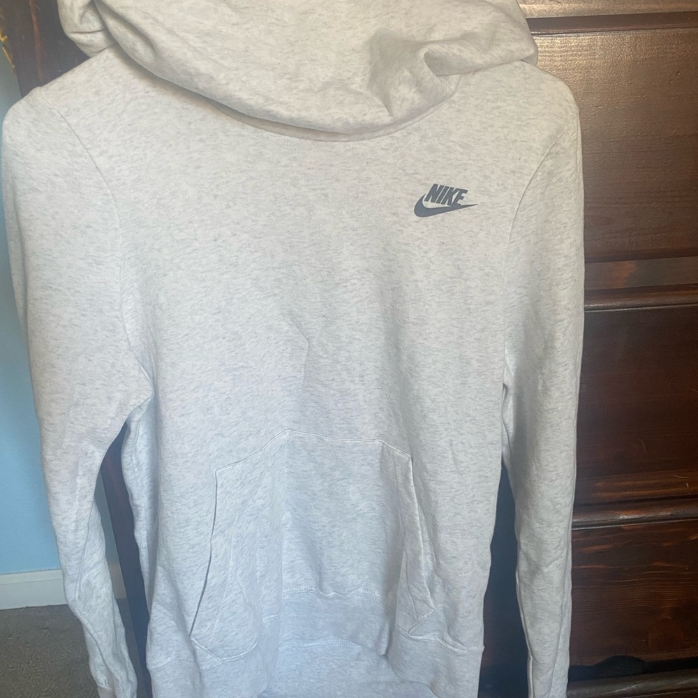 Has a big hoodie, turtle neck.